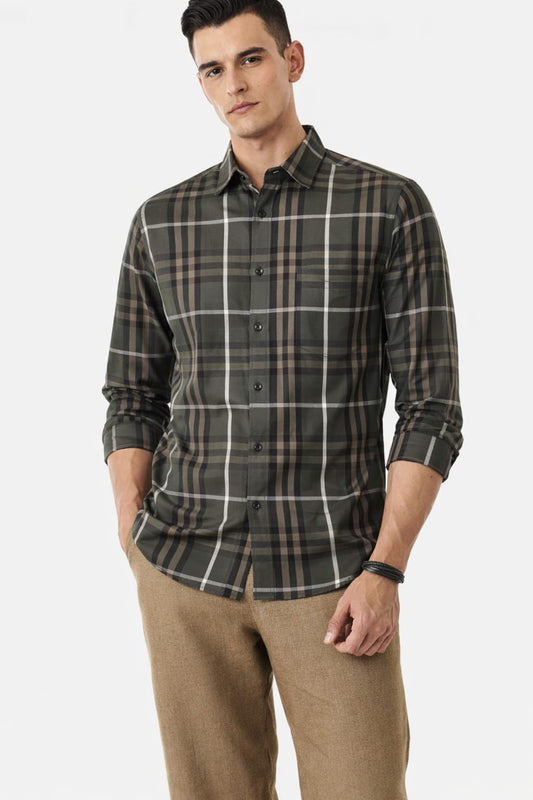 Man wearing a plaid shirt and beige pants on a white background