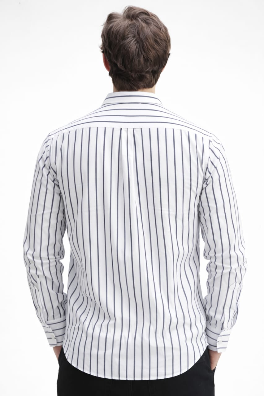 Person wearing a white shirt with black vertical stripes on a white background