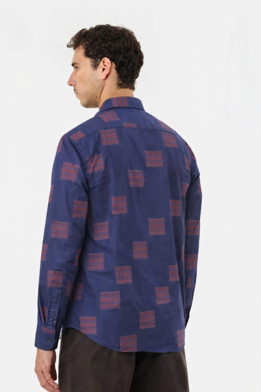 Man wearing a blue patterned shirt on a white background