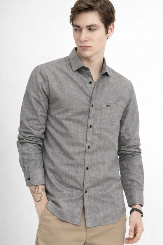 Man wearing a gray checkered shirt on a white background