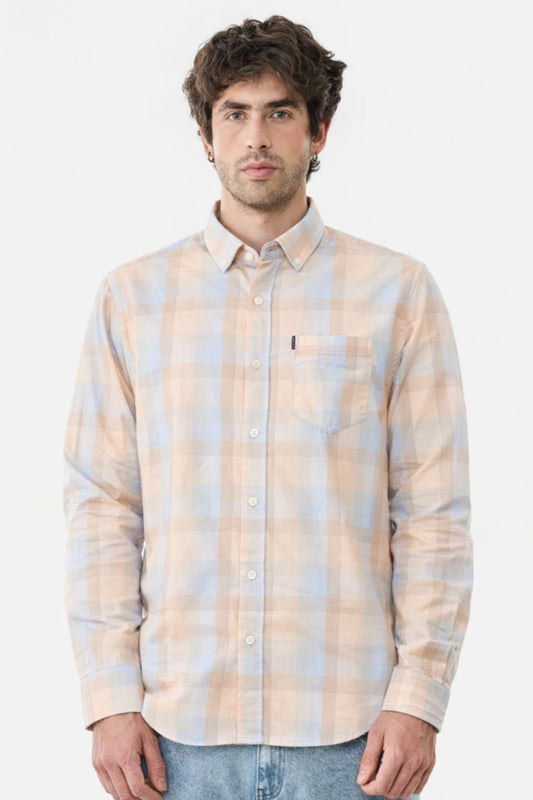 Man wearing a plaid shirt with a subtle pattern on a white background
