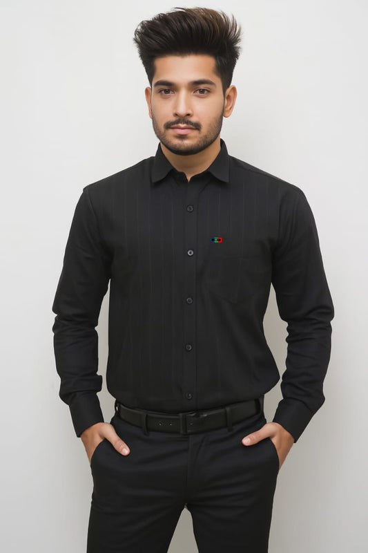 Man wearing a black dress shirt with a small red and yellow emblem on a white background