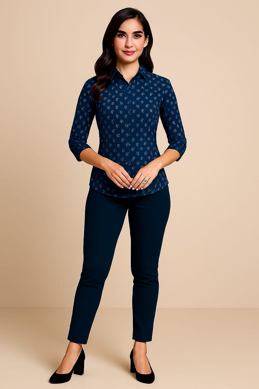 Woman wearing a navy blue patterned top and pants on a beige background