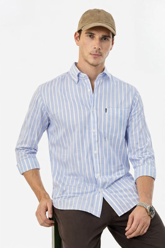 Man wearing a light blue striped shirt and brown cap on a white background