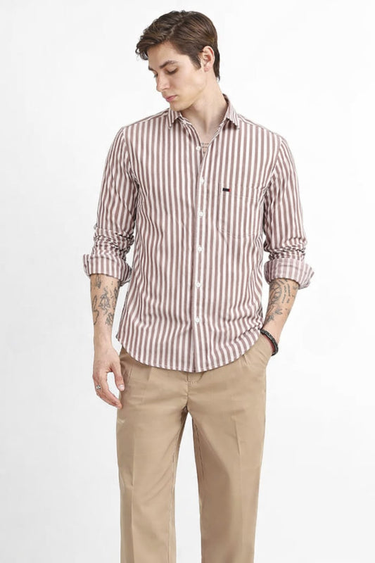 Man wearing a striped shirt and beige pants on a white background