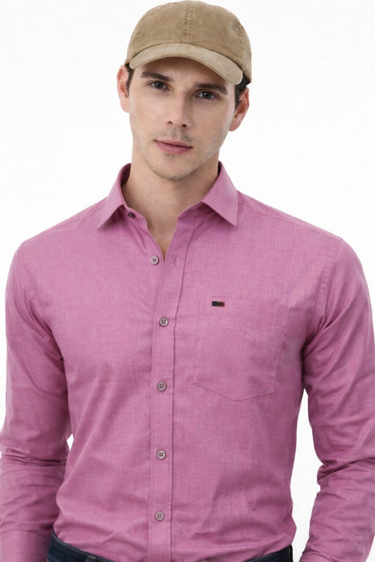 Man wearing a pink shirt and beige cap on a white background