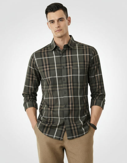 Man wearing a plaid shirt and beige pants on a white background