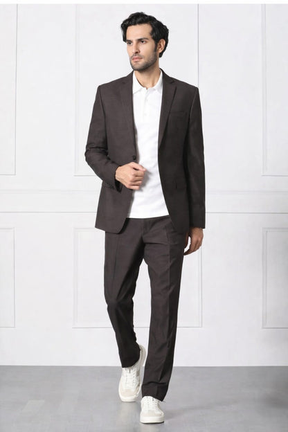 Man wearing a brown suit with a white shirt and white sneakers on a white background