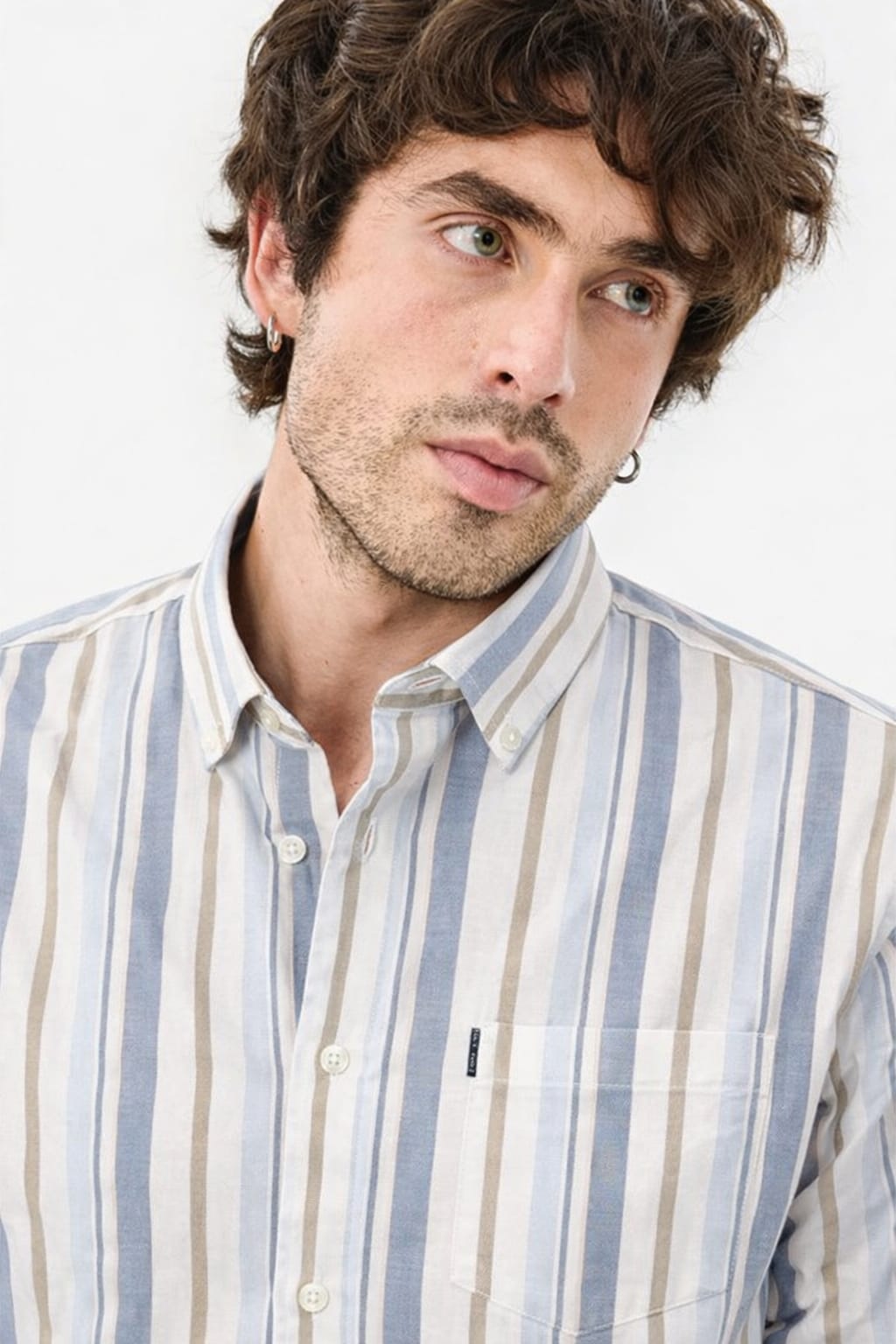 Man wearing a striped shirt against a white background