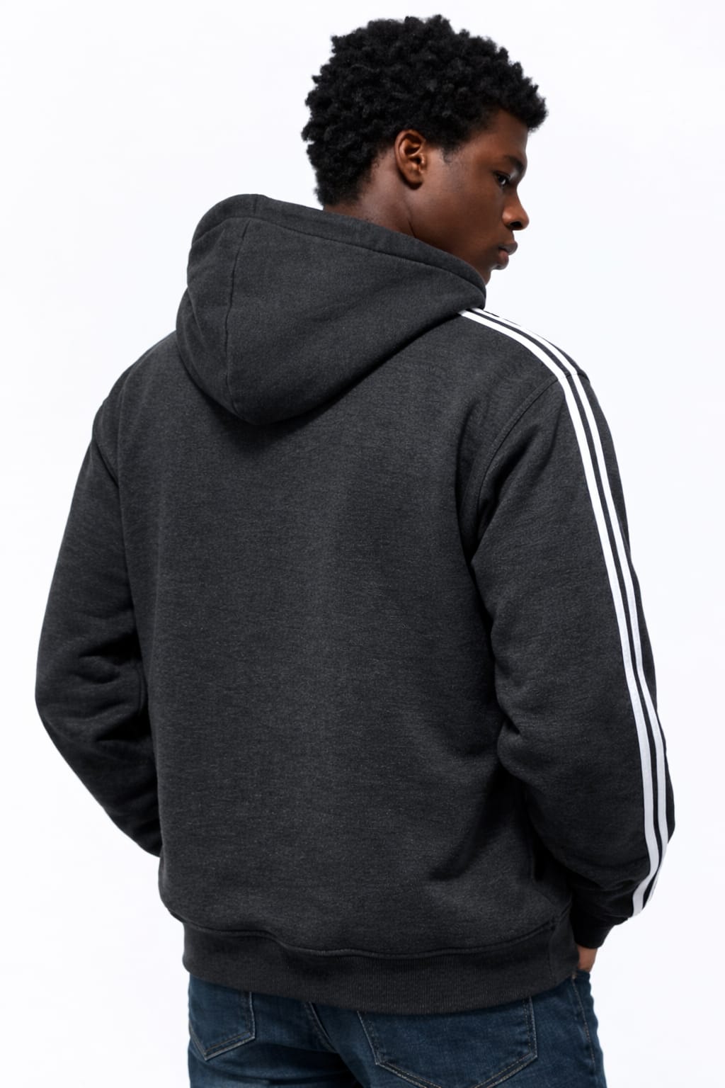 Person wearing a dark gray hoodie with white stripes on the sleeve, facing away from the camera.