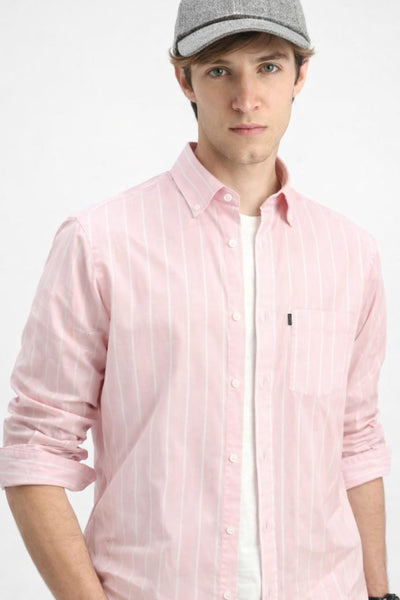 Man wearing a pink striped shirt and gray cap on a white background