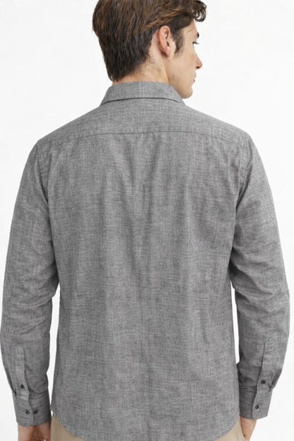 Man wearing a gray checkered shirt on a white background