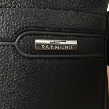 Close-up of a black leather bag with 'RAINMAIND' branding.