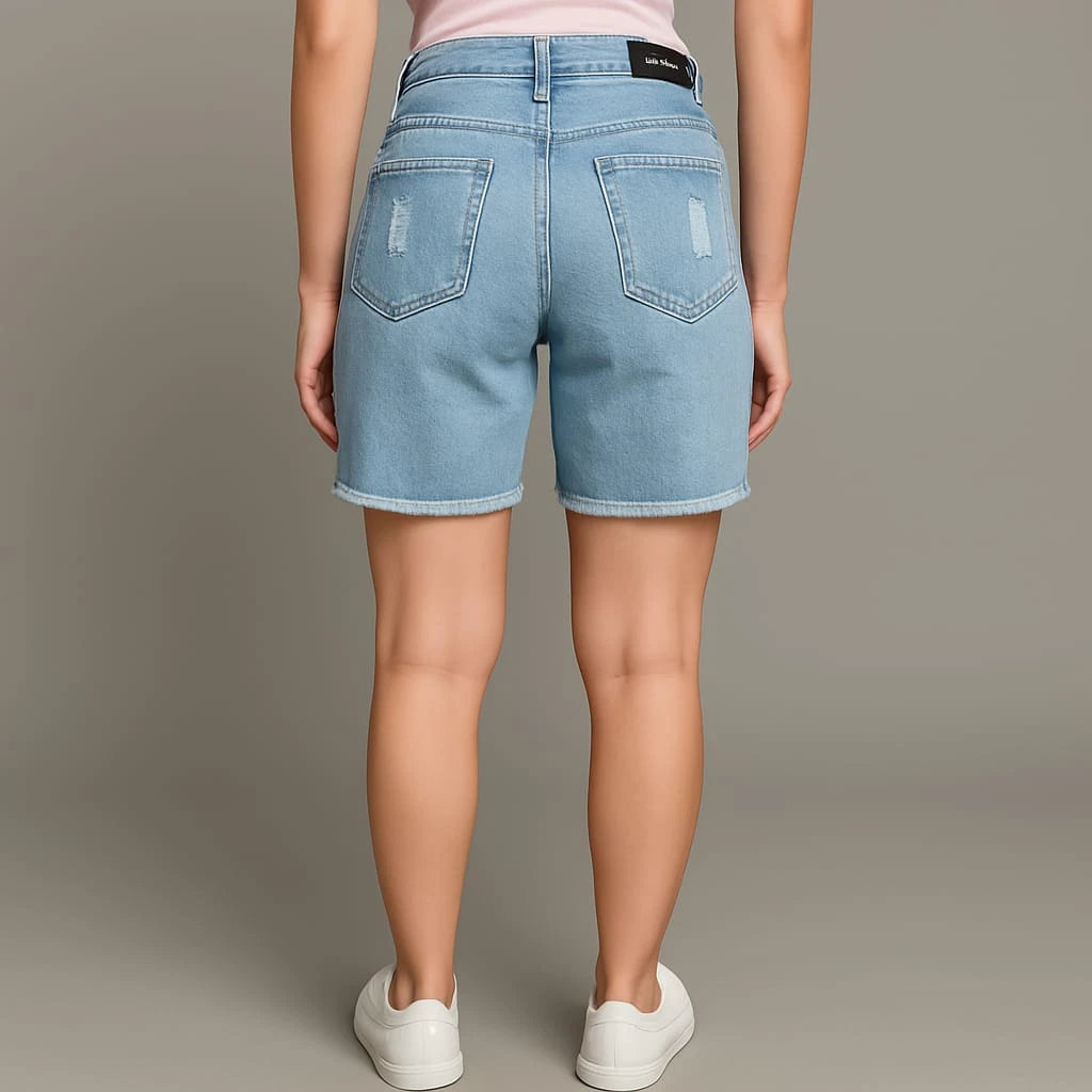 Person wearing light blue denim shorts on a plain background