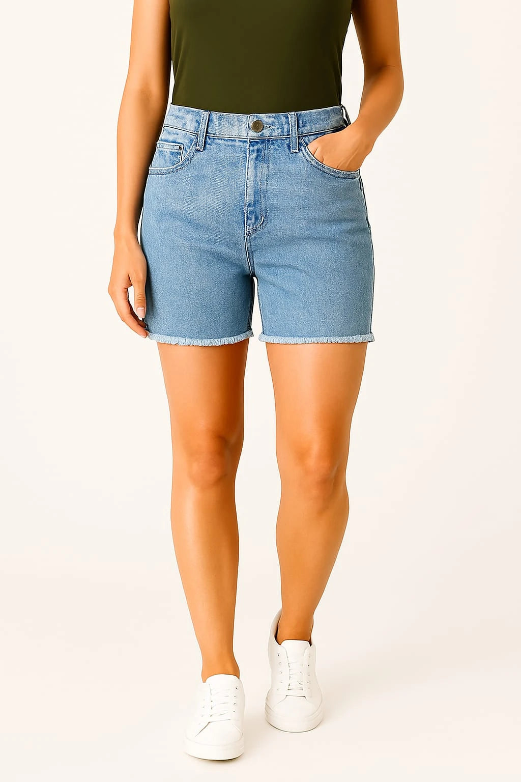 Person wearing light blue denim shorts on a white background
