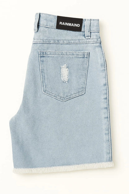 Light blue denim skirt with a frayed hem on a white background