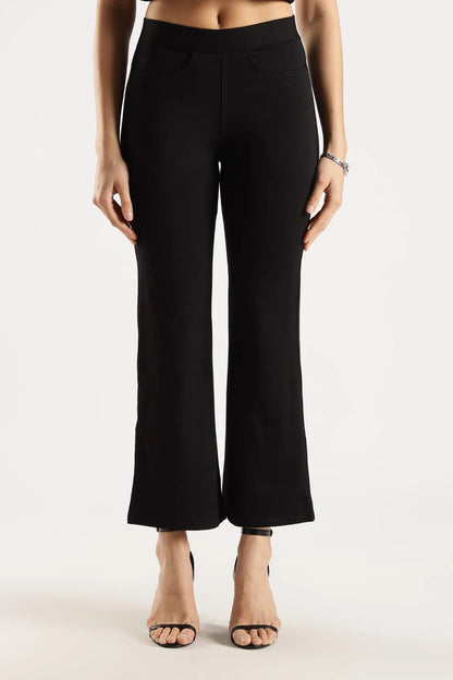 Person wearing black high-waisted pants on a white background