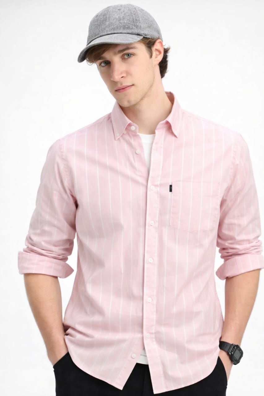 Man wearing a light pink shirt and gray cap on a white background