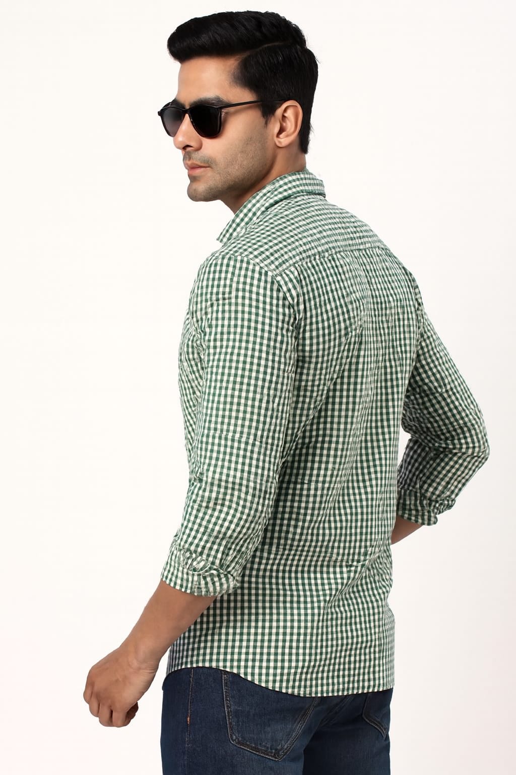 Man wearing a green checkered shirt and sunglasses on a white background