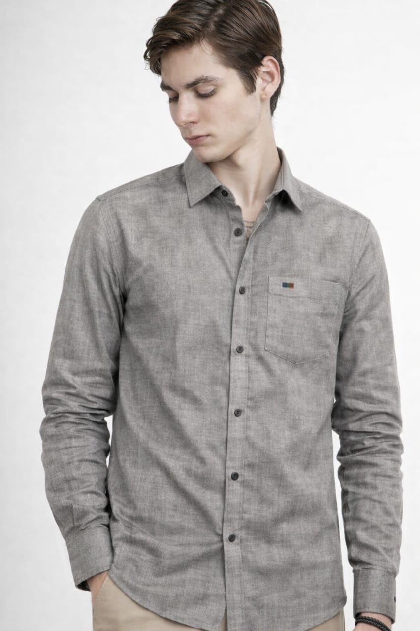 Man wearing a gray button-up shirt with a brand logo on a white background