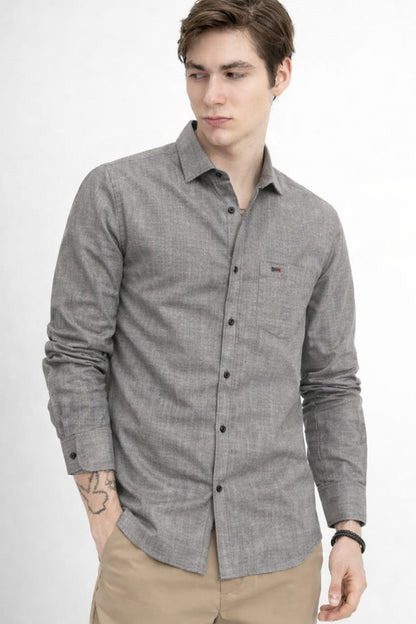 Man wearing a gray checkered shirt on a white background