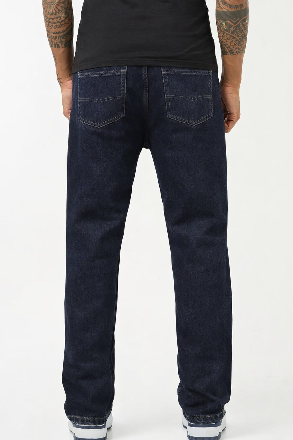 Person wearing dark blue jeans on a white background