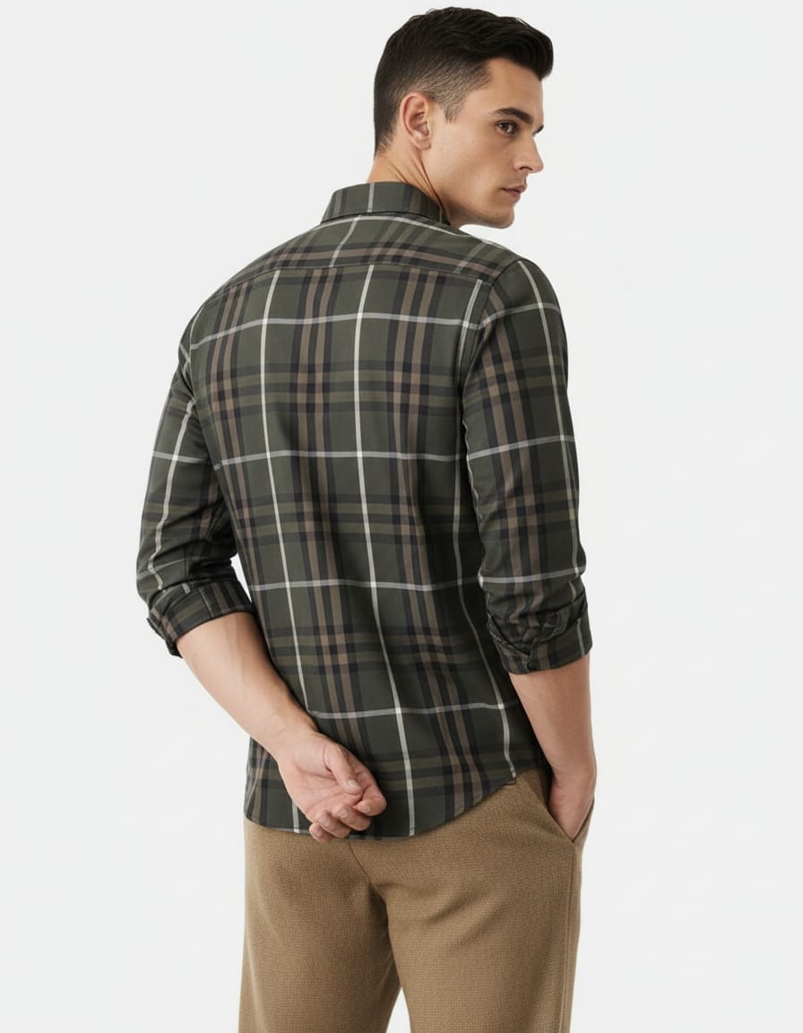 Man wearing a plaid shirt and beige pants on a white background