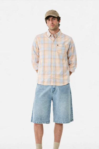 Man wearing a plaid shirt and denim shorts on a white background