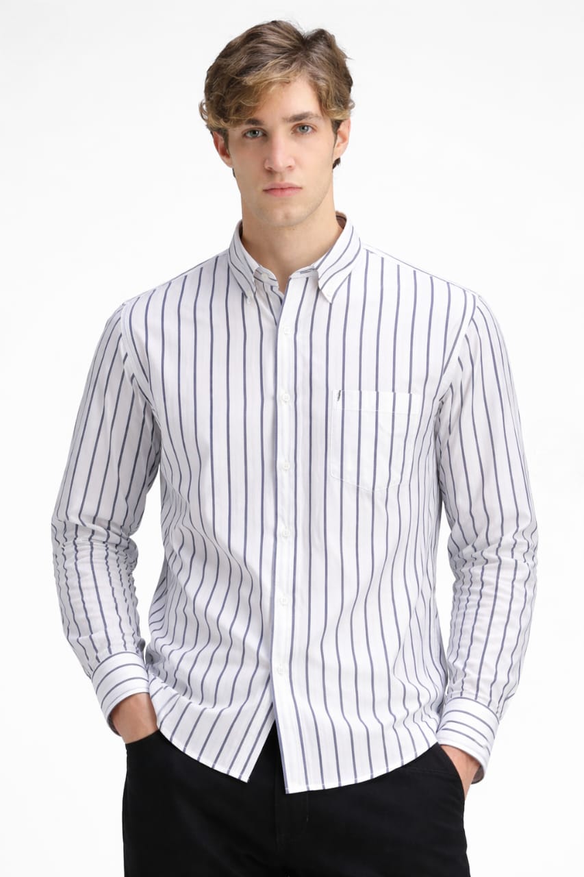 Man wearing a white shirt with black vertical stripes on a white background