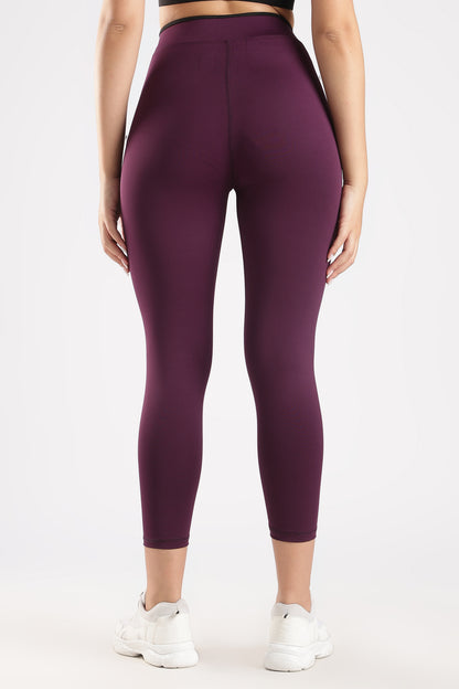 Purple leggings worn by a person on a white background