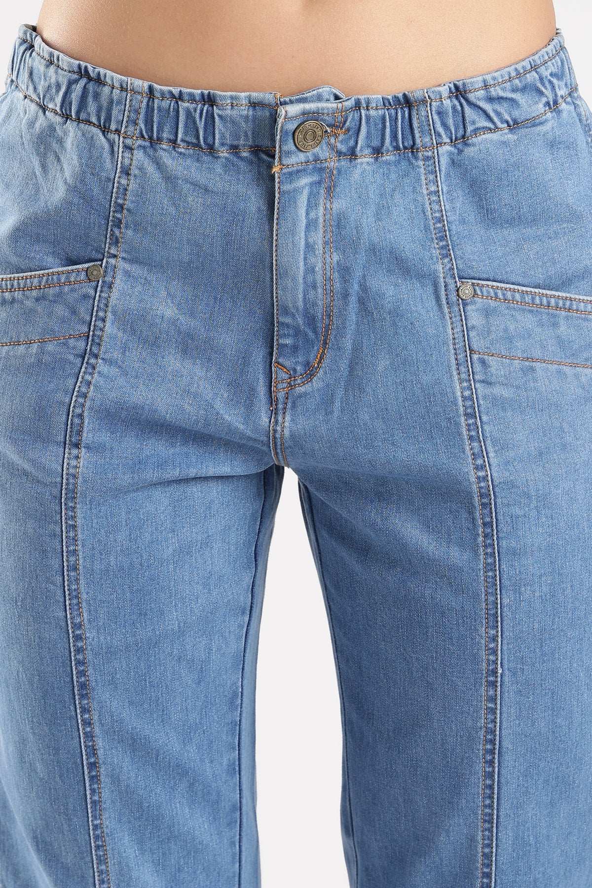 Close-up of blue jeans with a plain background