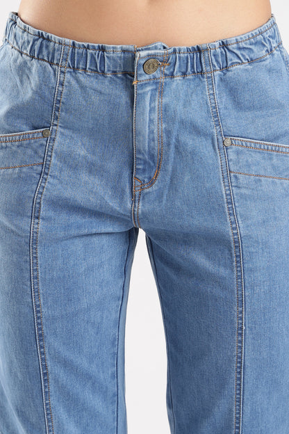 Close-up of blue jeans with a plain background