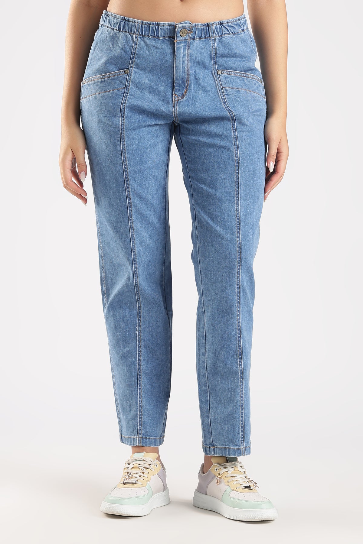 Light blue jeans worn by a person on a white background