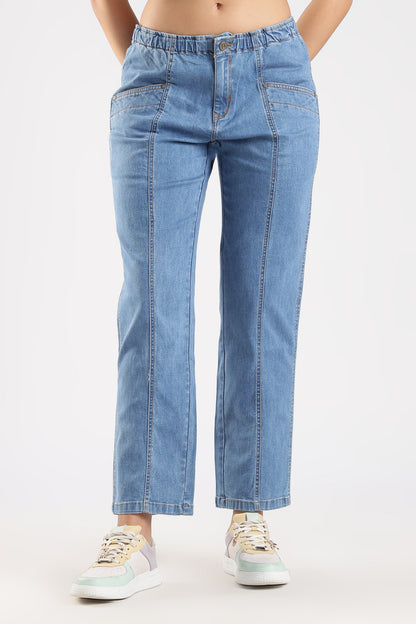 Person wearing light blue jeans on a white background