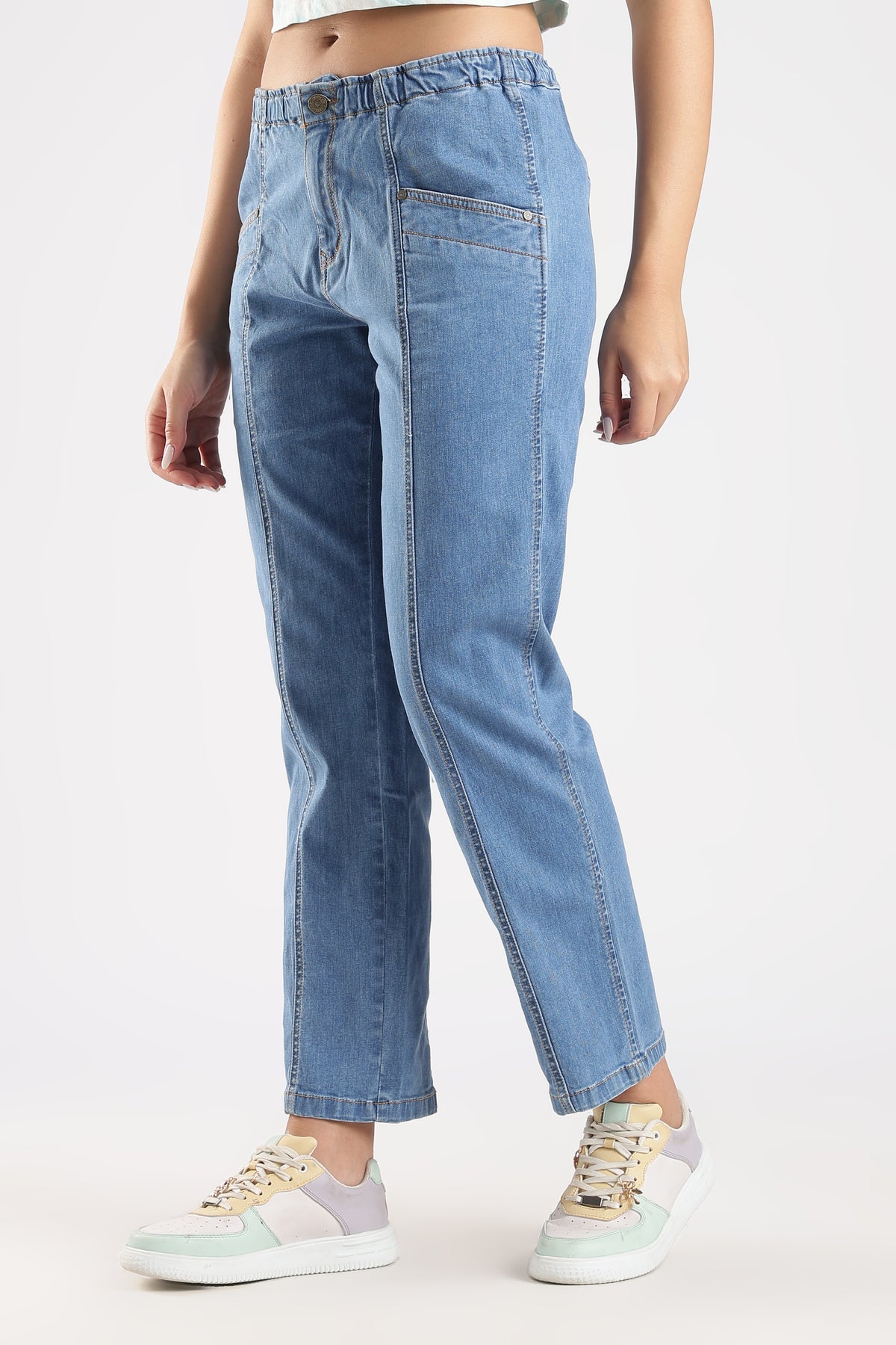Light blue jeans worn by a person on a white background