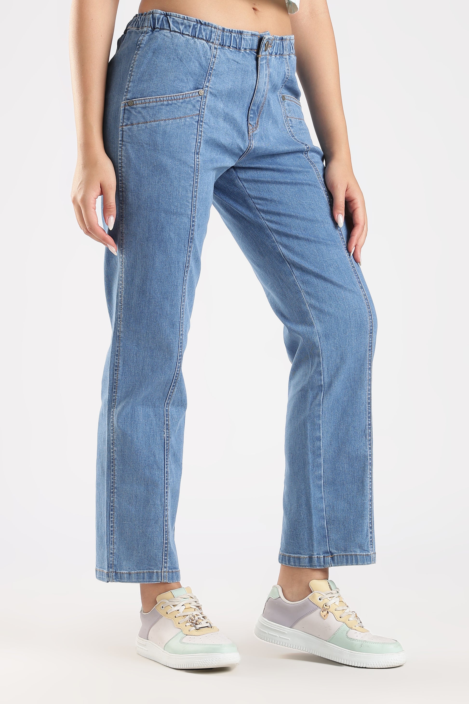 Person wearing light blue jeans on a white background