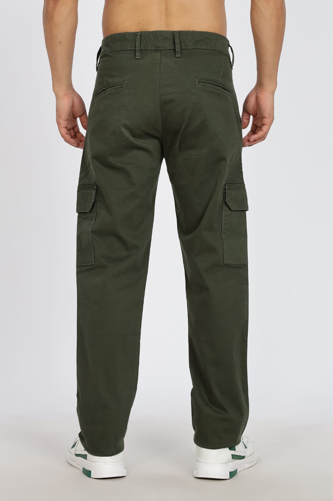 Green cargo pants worn by a person on a white background