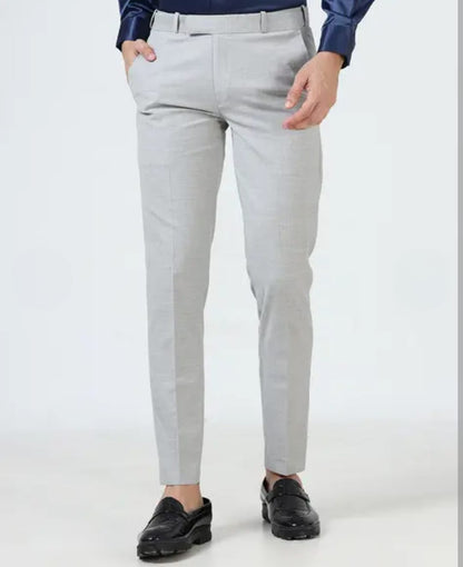 Light gray dress pants worn by a person on a white background