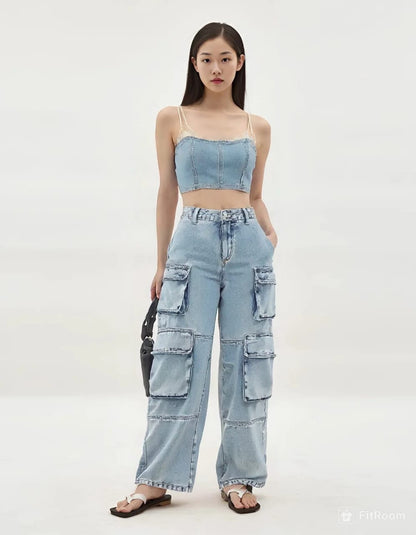 Woman wearing a light blue denim outfit with a white background