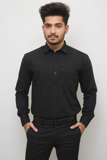 Man wearing a black dress shirt with a small red and yellow emblem on a white background