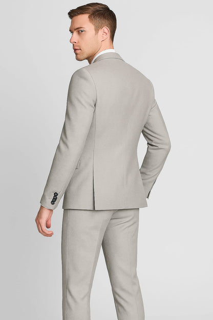 Man wearing a light gray suit on a plain background