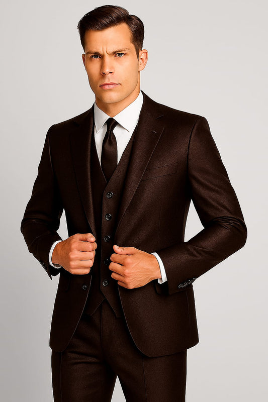 Man wearing a brown suit with a white shirt and black tie on a gray background