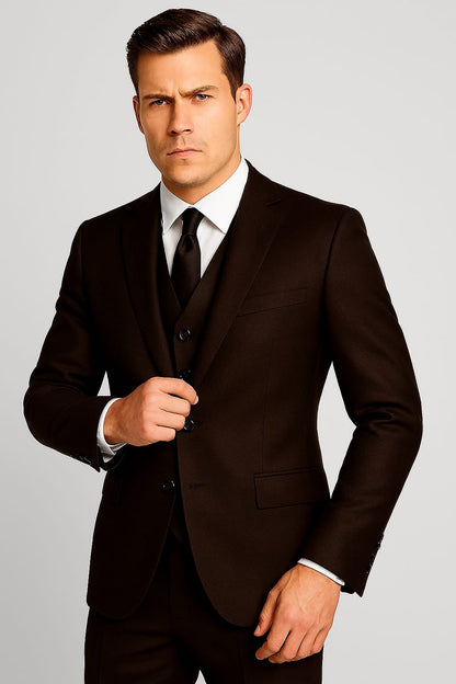 Man wearing a black suit and tie on a gray background