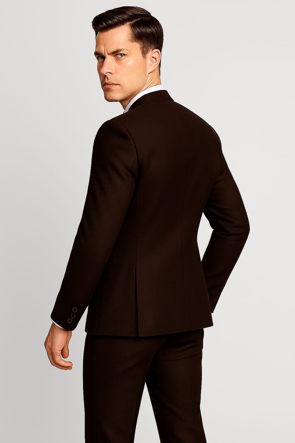 Man wearing a brown suit against a light gray background