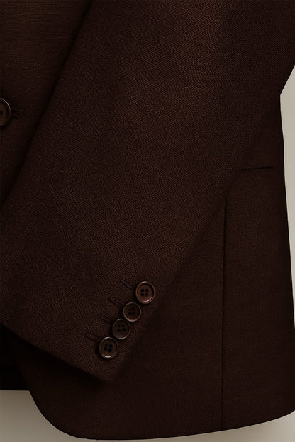 Close-up of a brown suit jacket with buttons on a light background