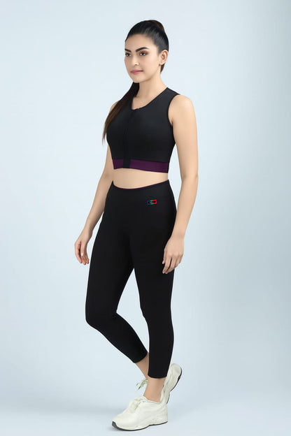 Woman wearing a black athletic outfit with a purple accent on a light gray background