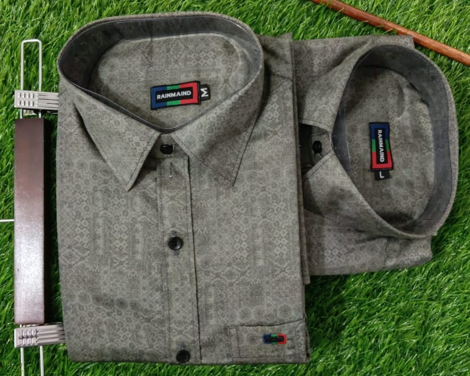 Gray patterned shirt with a brand label on a grass background