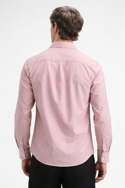 Person wearing a pink shirt on a white background