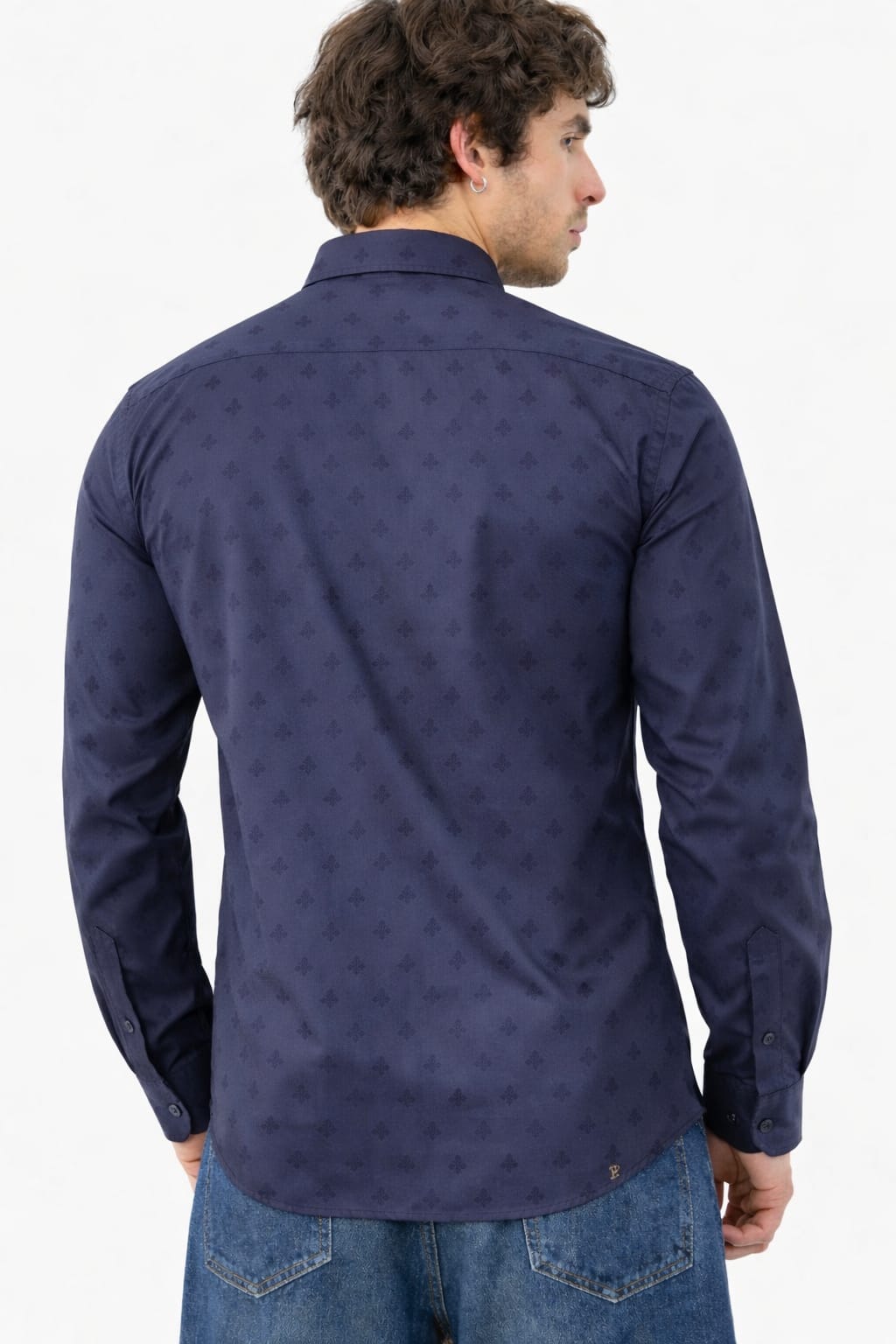 Man wearing a navy blue patterned shirt against a white background