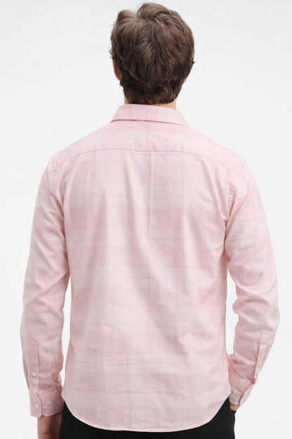 Person wearing a light pink shirt on a white background